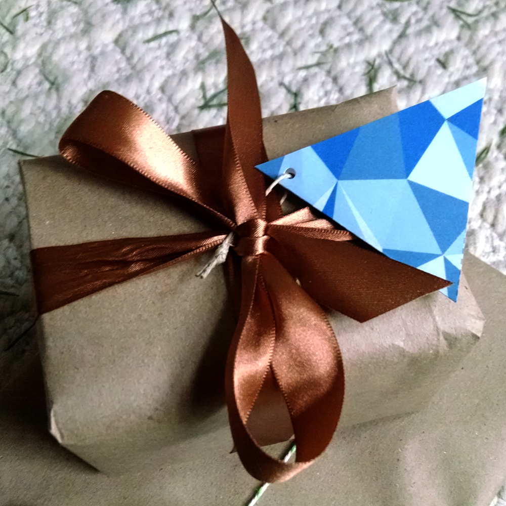 an origami bird on top of a wrapped present
