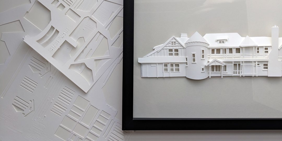 a paper model of a house on display