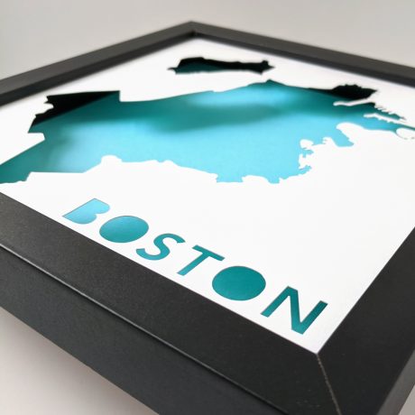 Side view of framed cut paper map of Boston, MA