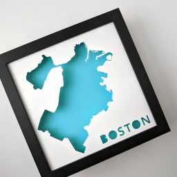 a black frame with a blue cut out of boston