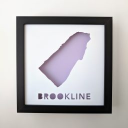 a black frame with a purple cut out of the outline of a city