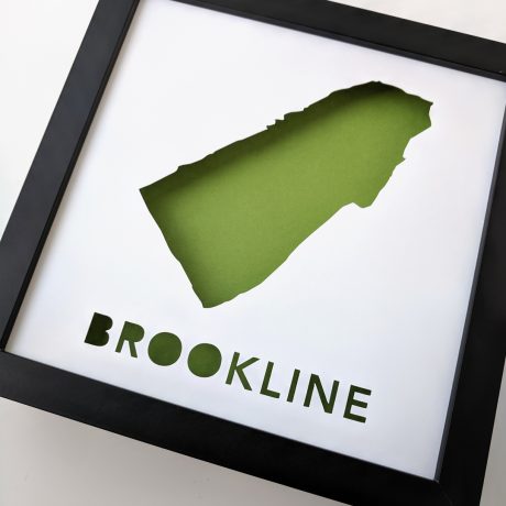 a black frame with a green cut out of the state of brooklyn