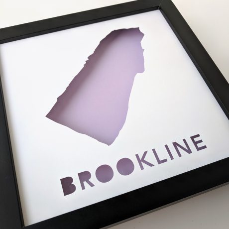 a black frame with a purple cut out of the shape of a state