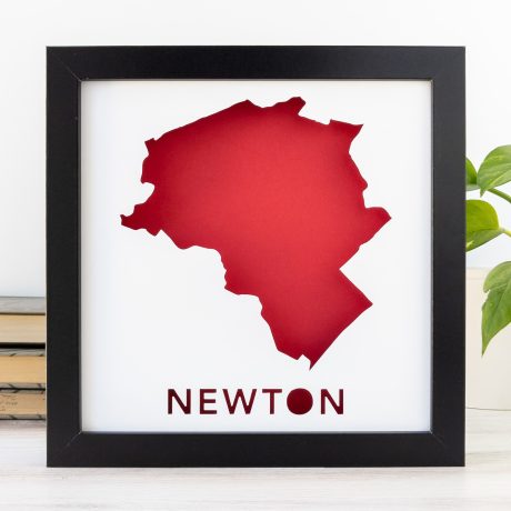 a black frame with a red map of Newton, MA