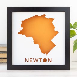 a black frame with an orange map of Newton, MA
