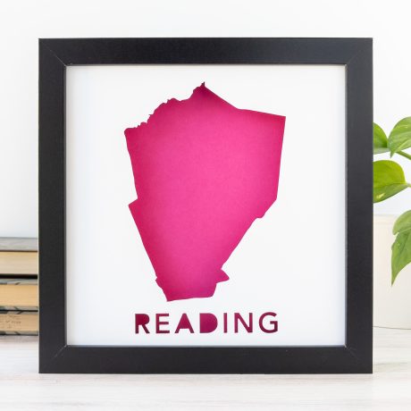 a pink cut-out silhouette of the city of Reading, MA