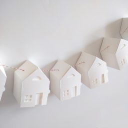 five paper houses hanging on a wall