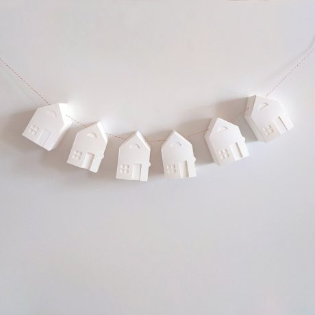 paper houses are hanging on a string