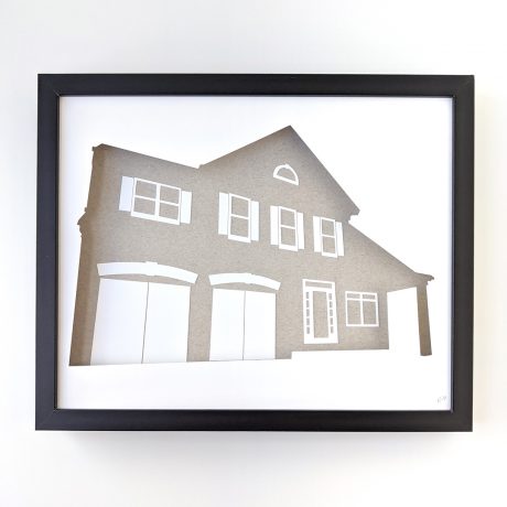 a paper cut out of a house with garage doors