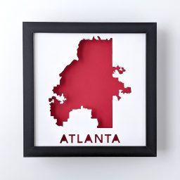 Framed map of Atlanta, Georgia cut out of white paper to reveal the red background