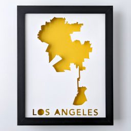 Framed map of Los Angeles, California cut out of white paper to reveal a yellow background