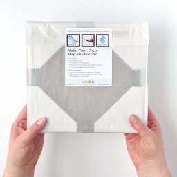 Packaged DIY Paper Place kit held in two hands